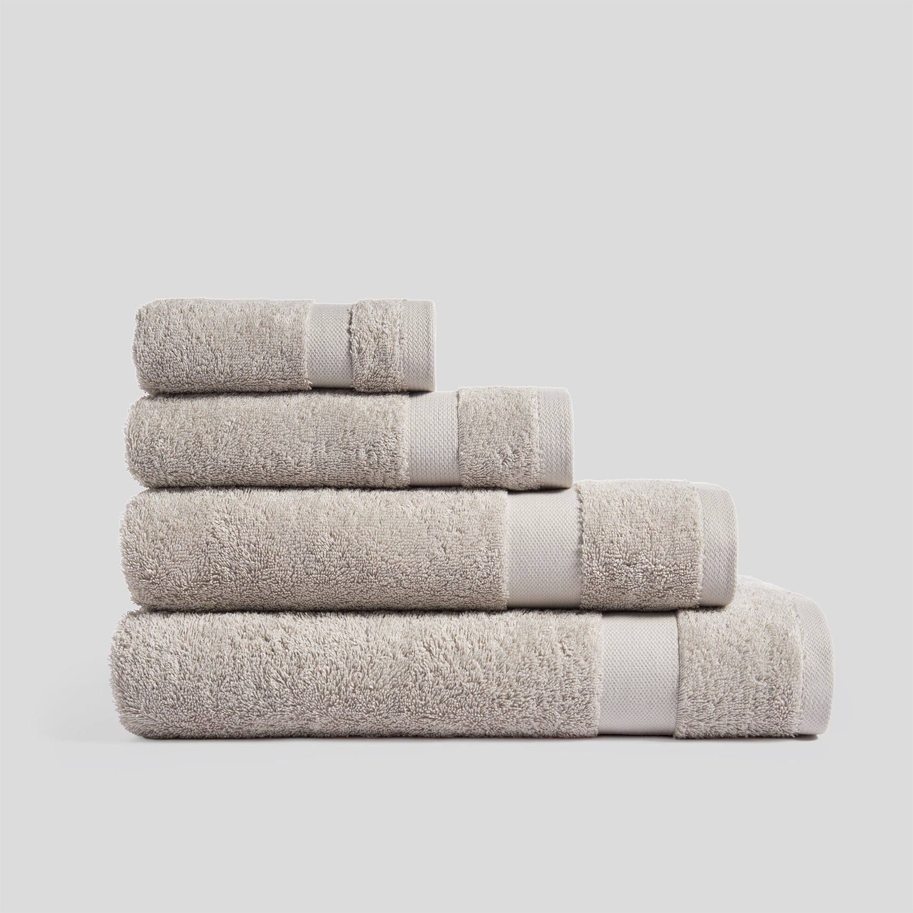 Stack of sand bath towels in soft cotton for everyday bathroom use and modern home decor.