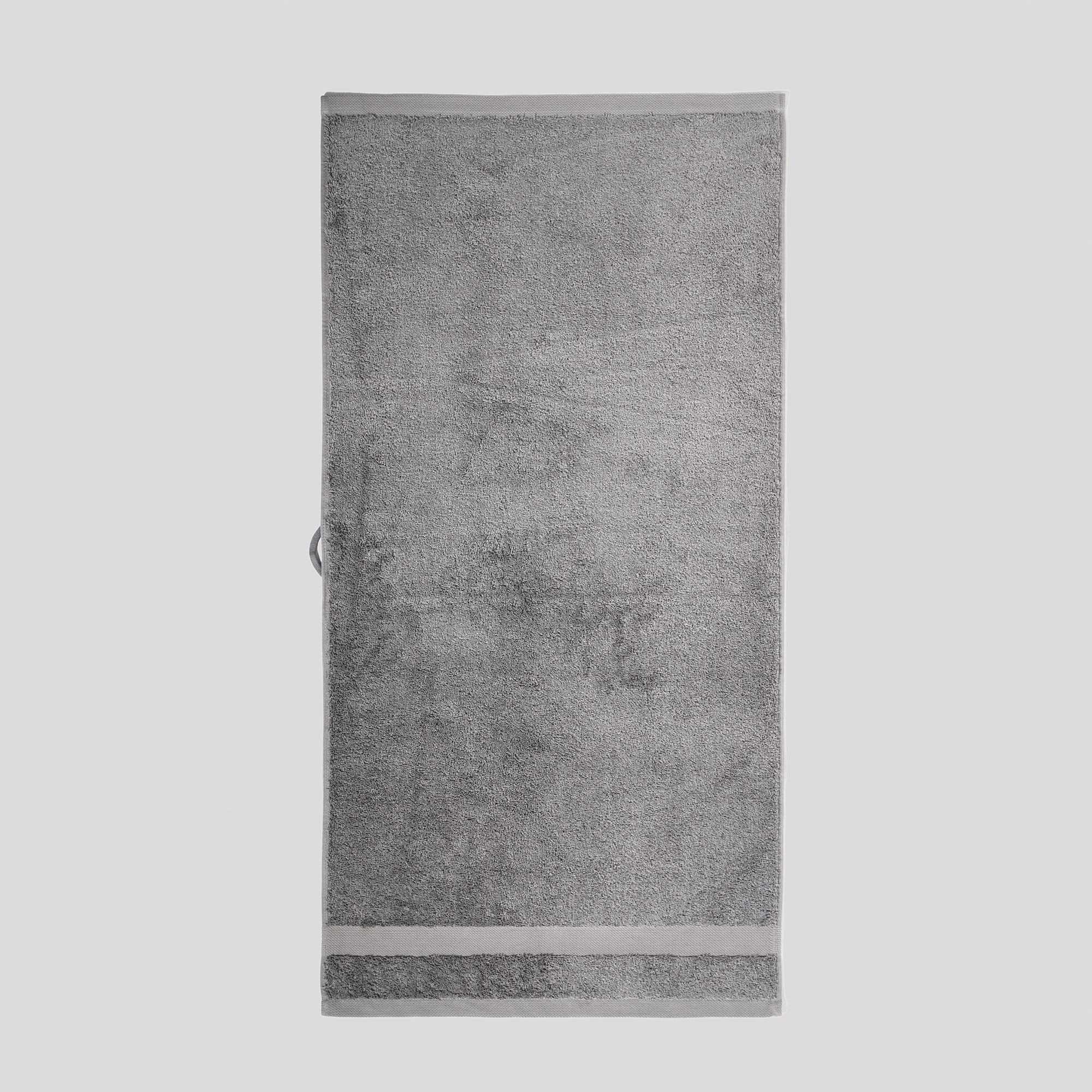 Giza bath towel laid flat with minimalist design and soft cotton texture.