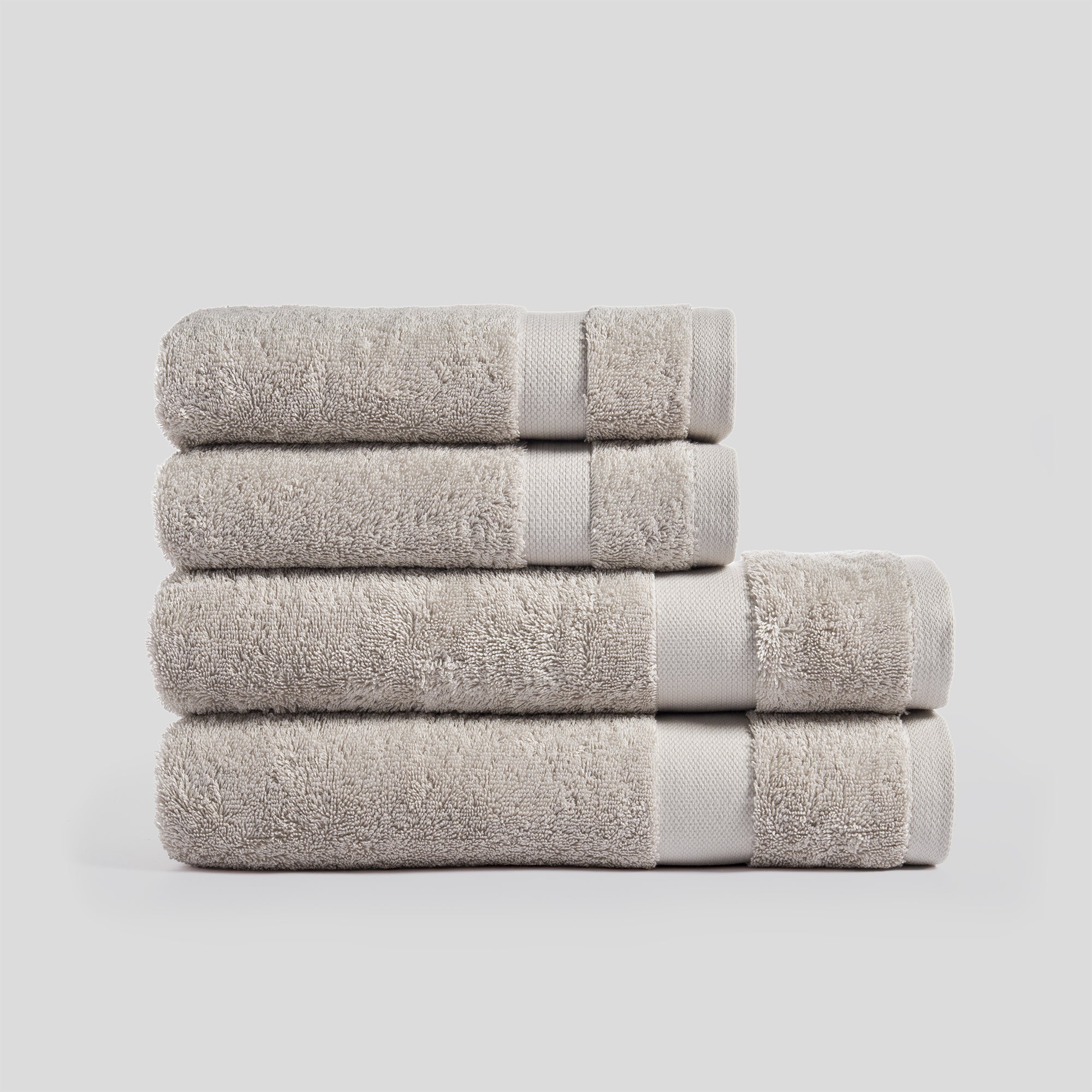 Stack of sand bath towels in soft cotton for everyday bathroom use and modern home decor.