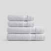 Stack of pure white bath towels in soft cotton for everyday bathroom use and modern home decor.