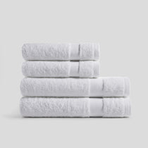 Pure white bathroom towel set made of soft absorbent cotton, ideal for modern home essentials.