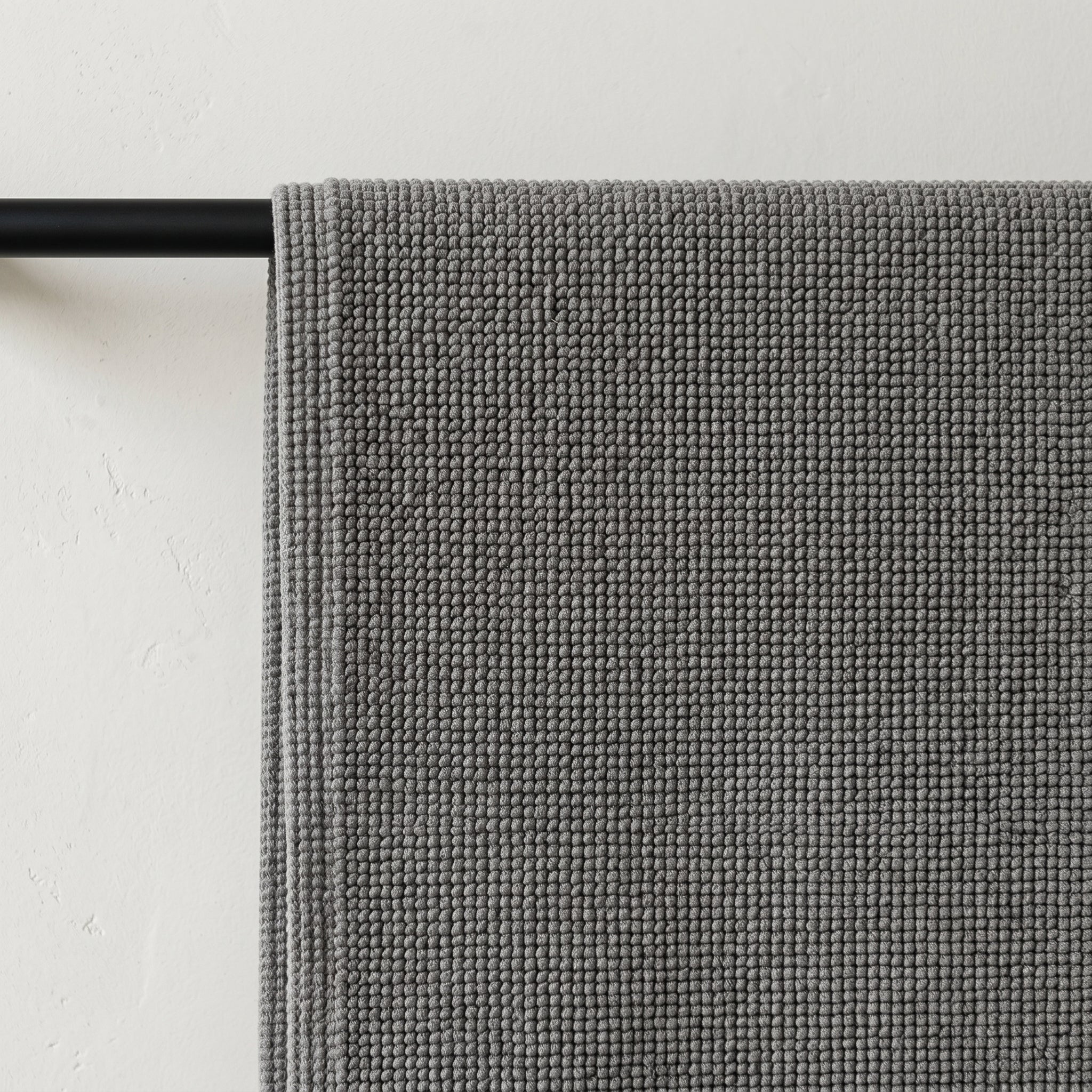 100% cotton bath mat with a dense woven texture and clean, minimalist finish.