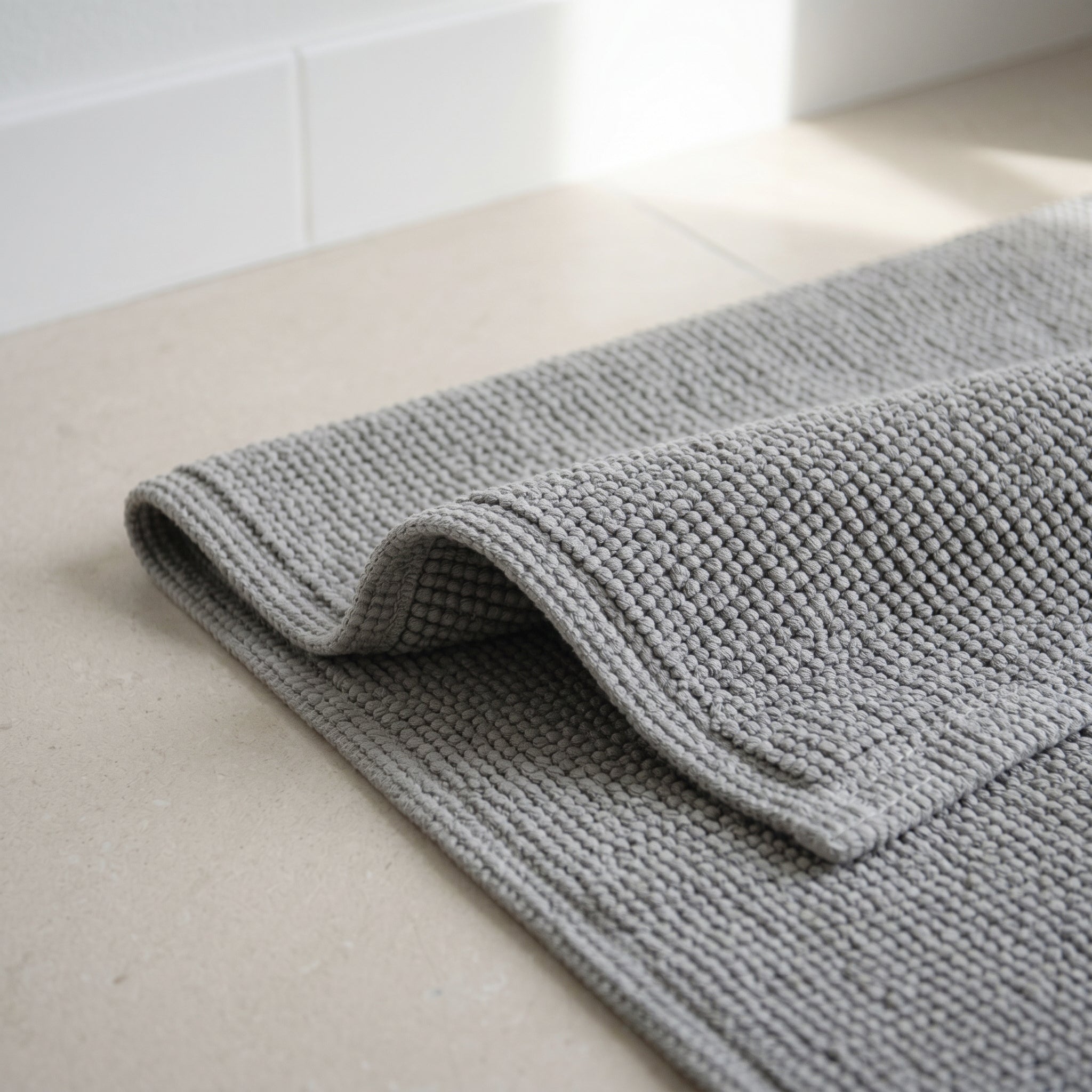 100% cotton bath mat with a textured woven surface and soft feel underfoot.