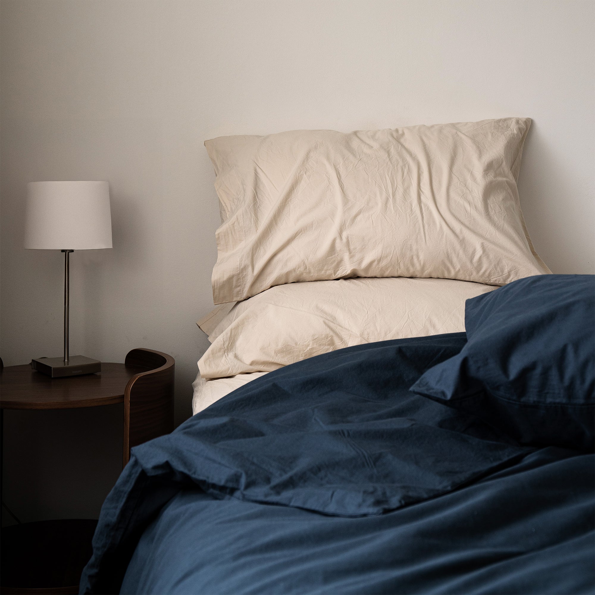 Pillowcases styled on a bed with a relaxed and naturally textured finish.