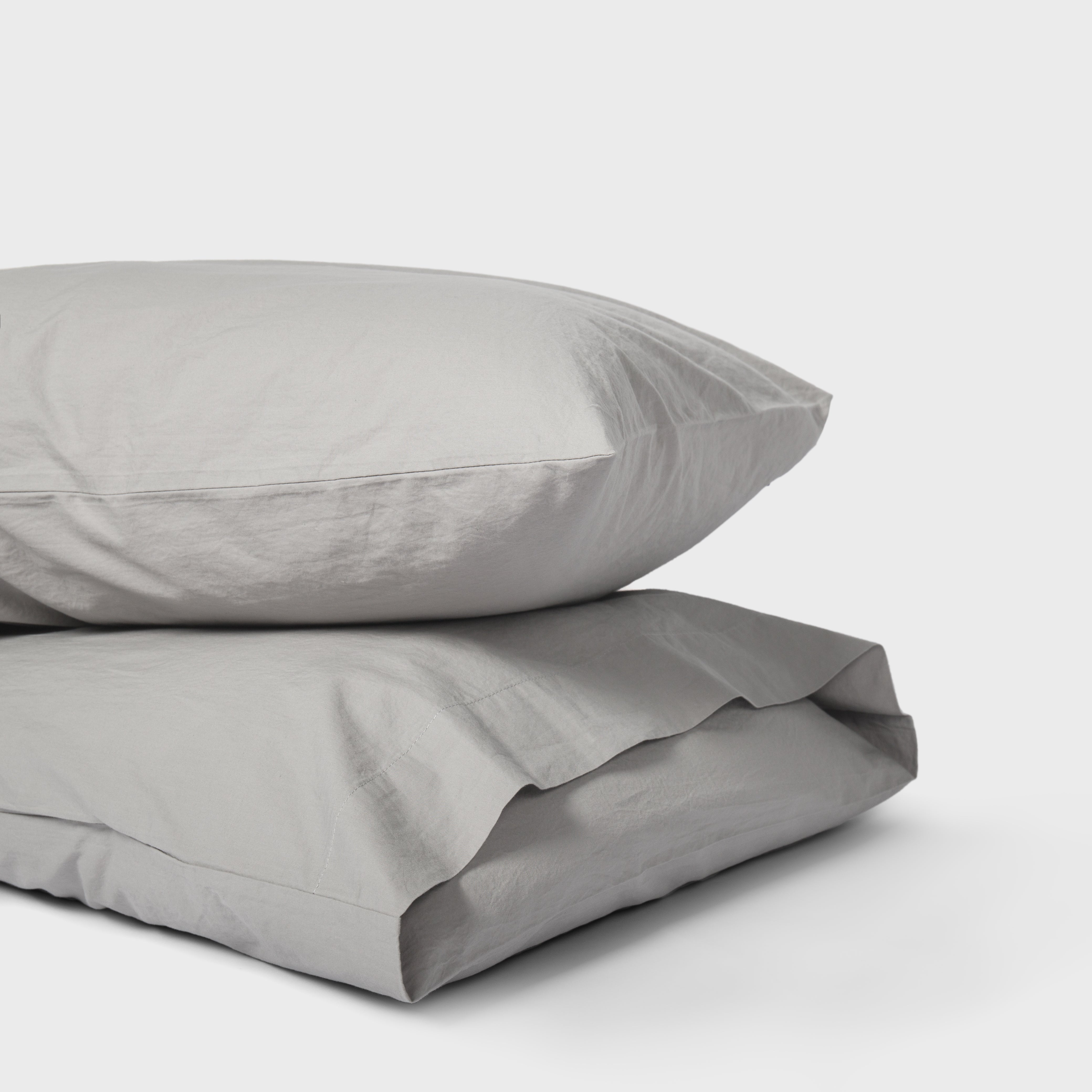 Set of two mist grey pillowcases in organic cotton for a serene bedroom feel.