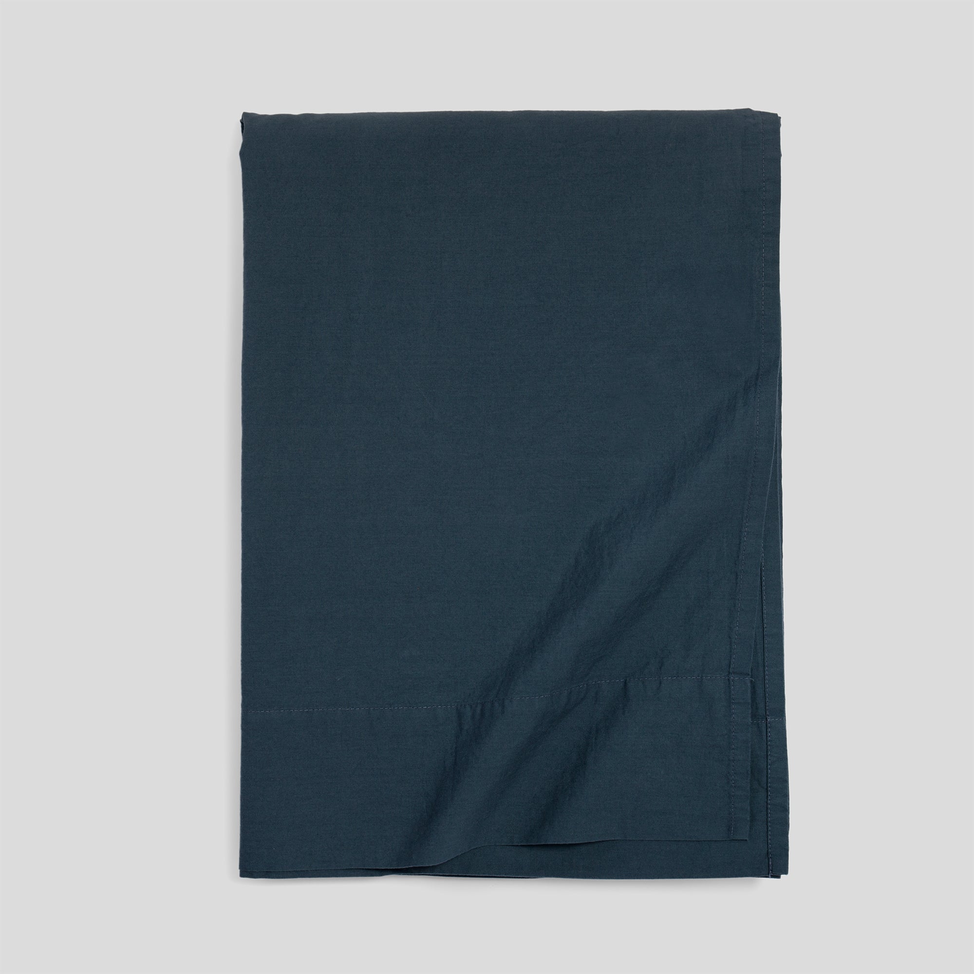 Atlantic blue organic cotton flat sheet folded for elegant, breathable and soft bed layering.
