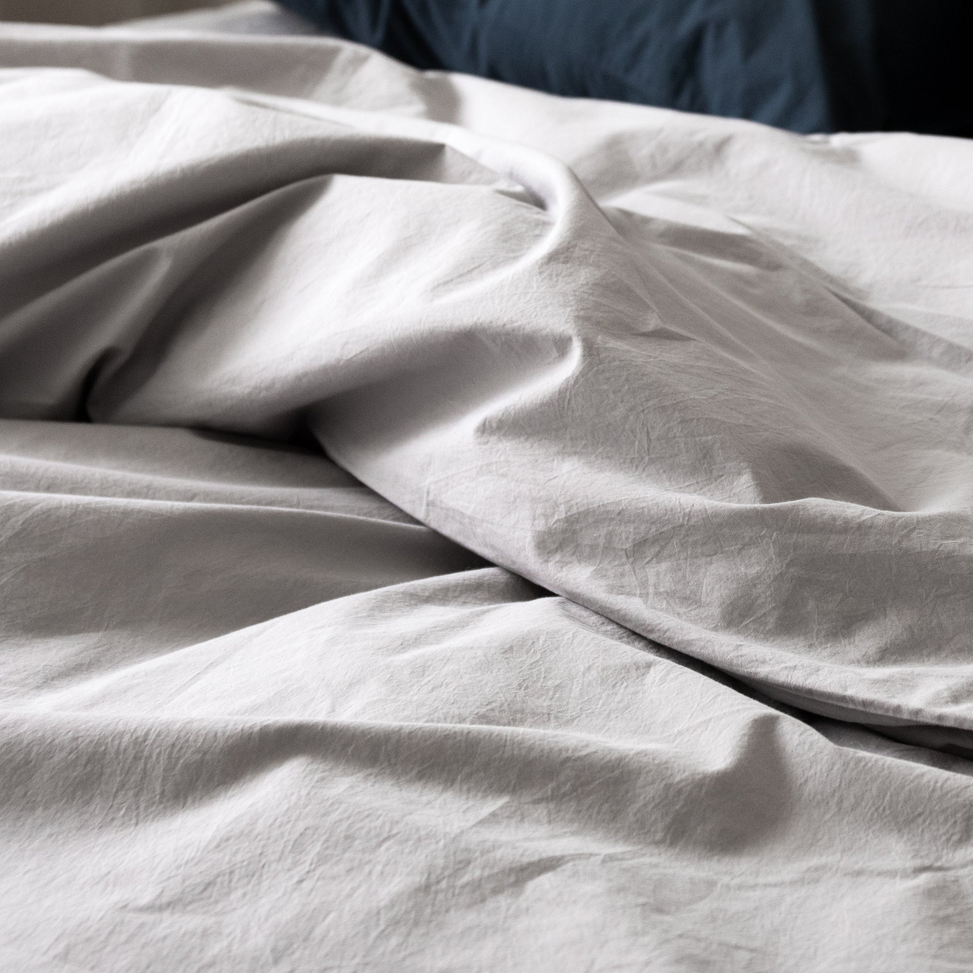 Close-up of duvet cover fabric with soft folds and a naturally relaxed texture.