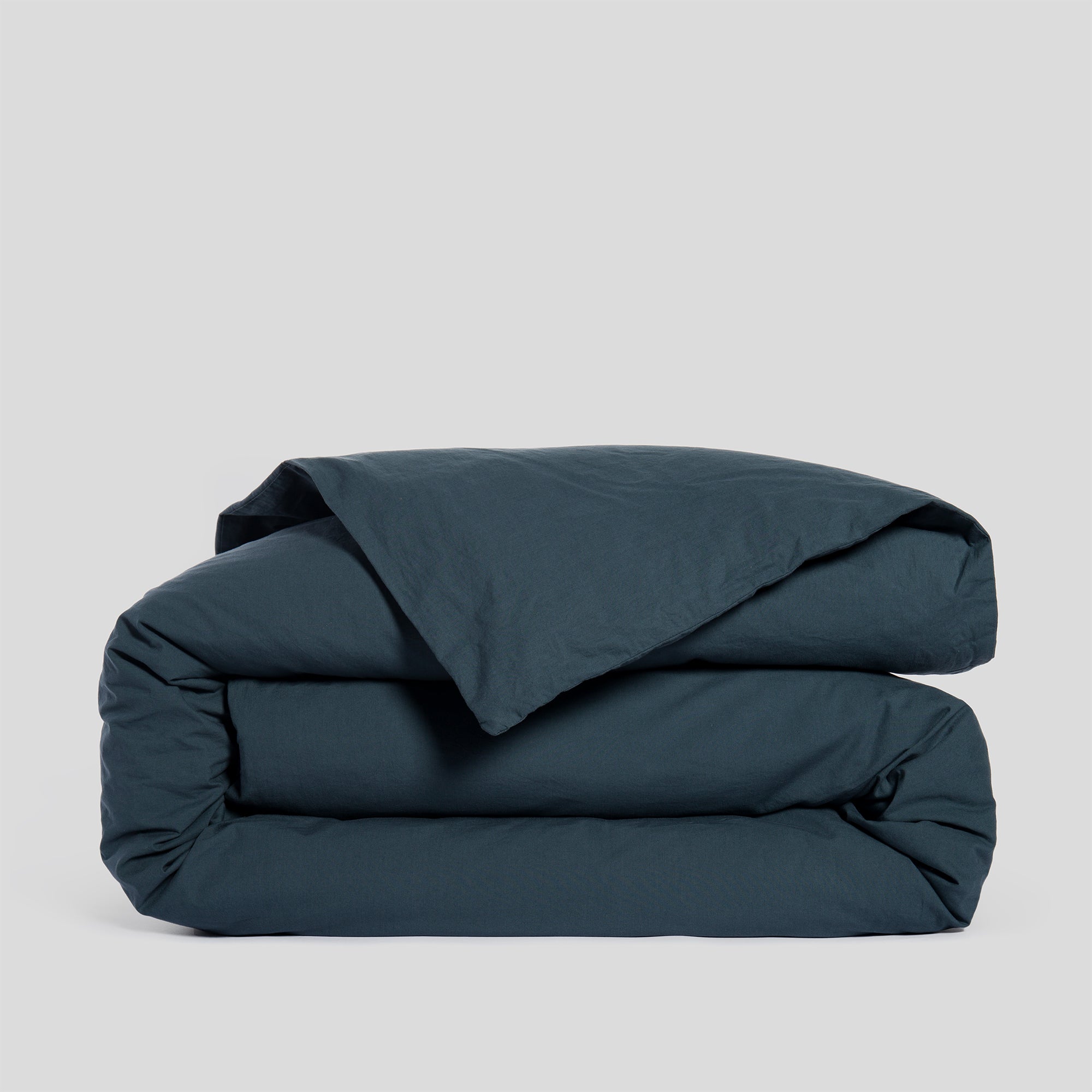 Folded atlantic blue duvet cover in soft and breathable organic cotton.