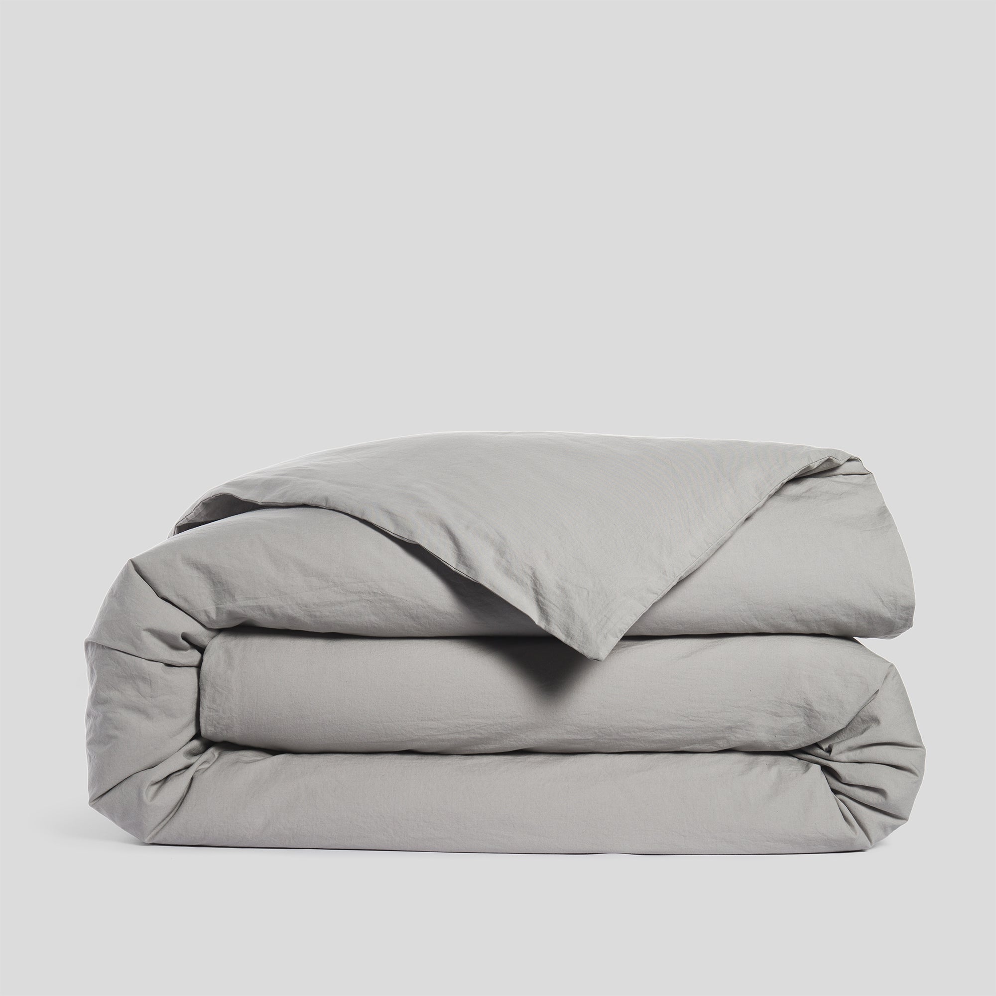 Folded mist grey duvet cover in soft and breathable organic cotton.