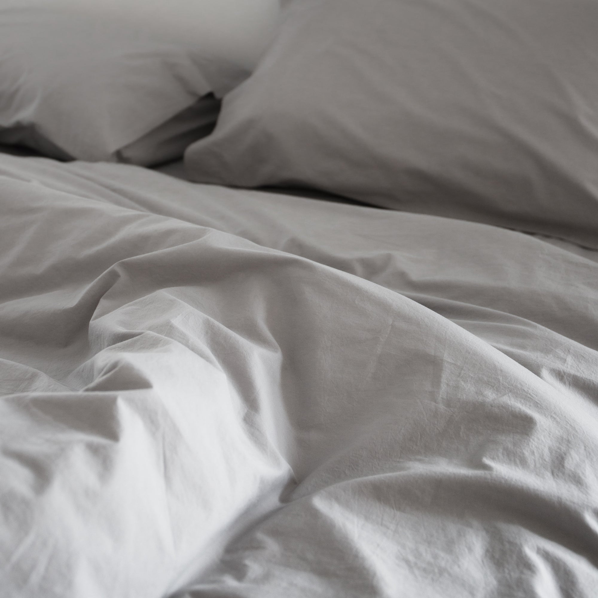 Close-up of a duvet cover set with matching pillowcases and a smooth relaxed texture.