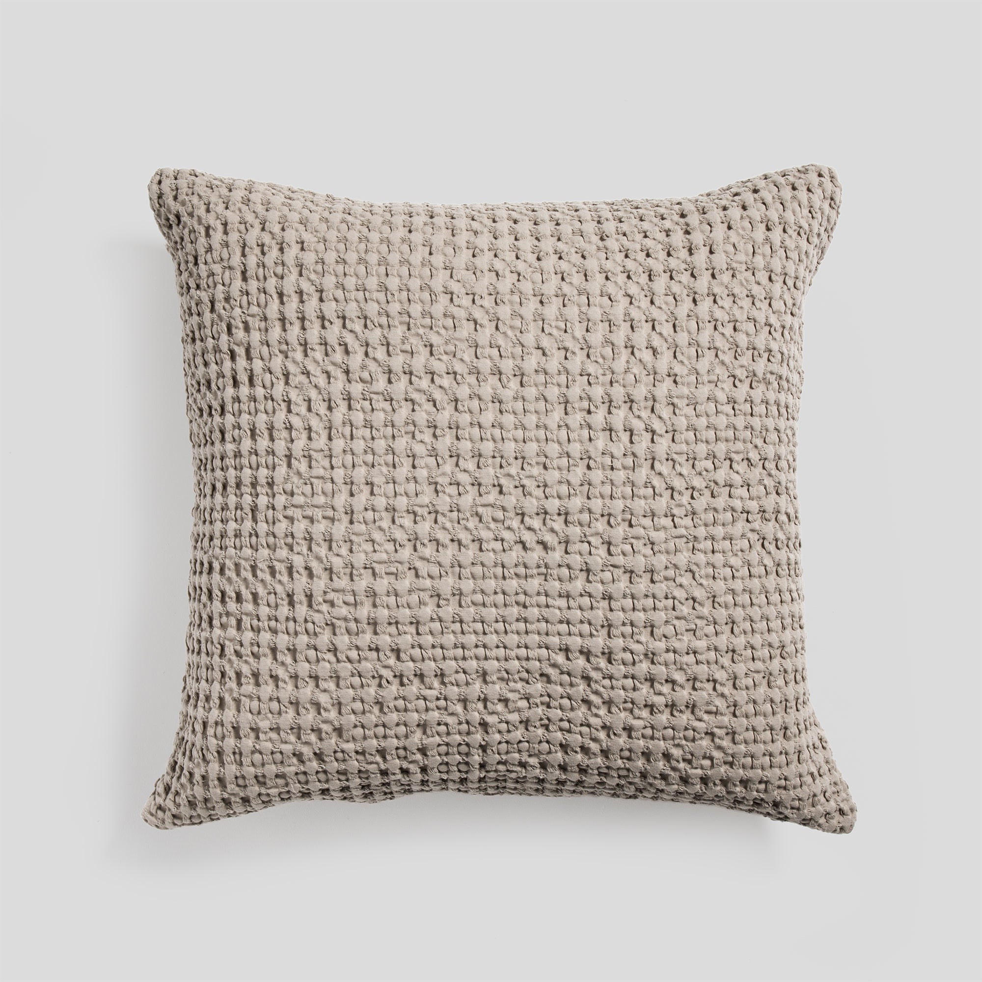 Cotton cushion cover in ash with a soft waffle texture fabric.