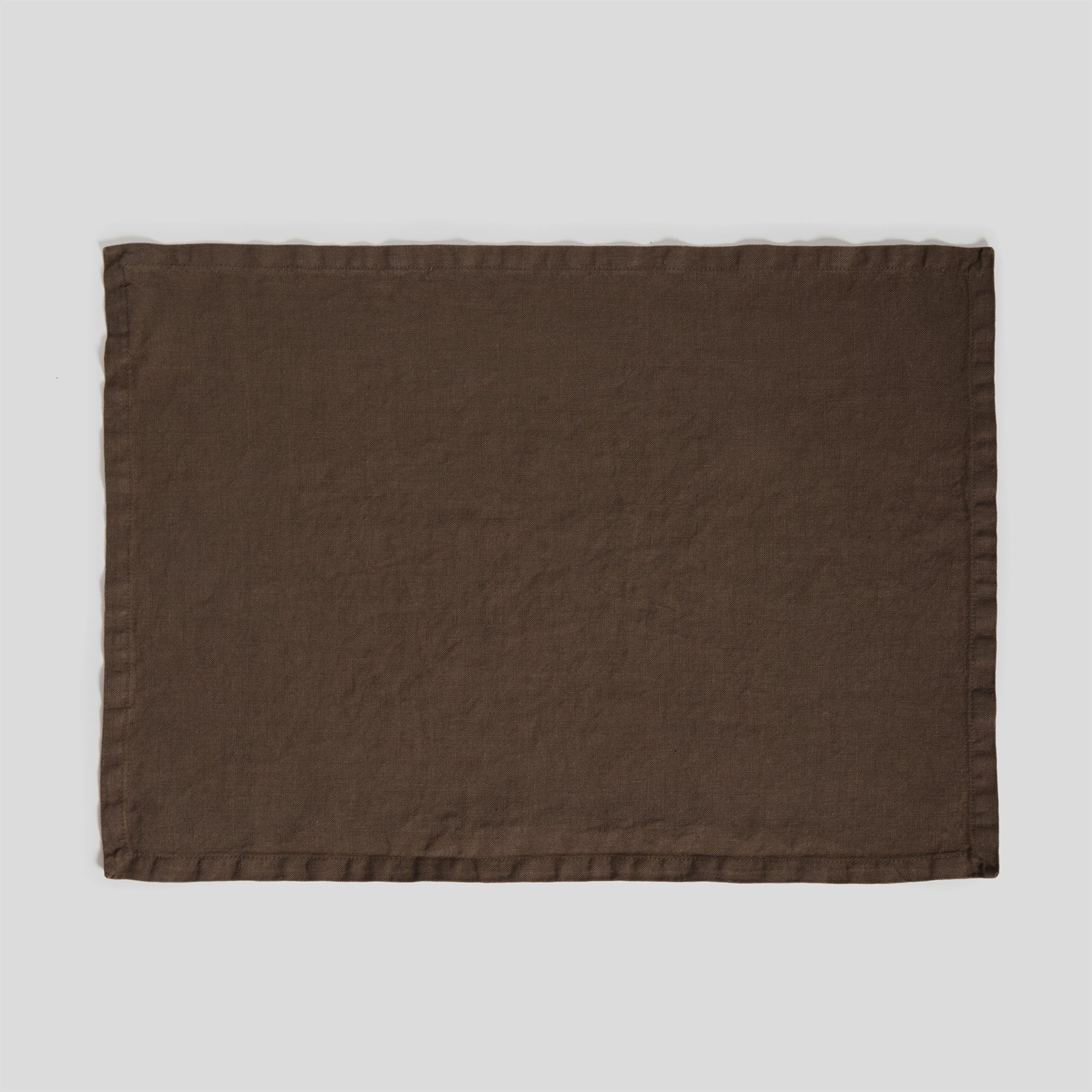 Sable heavy linen placemat featuring a rich, textured weave and clean edges.