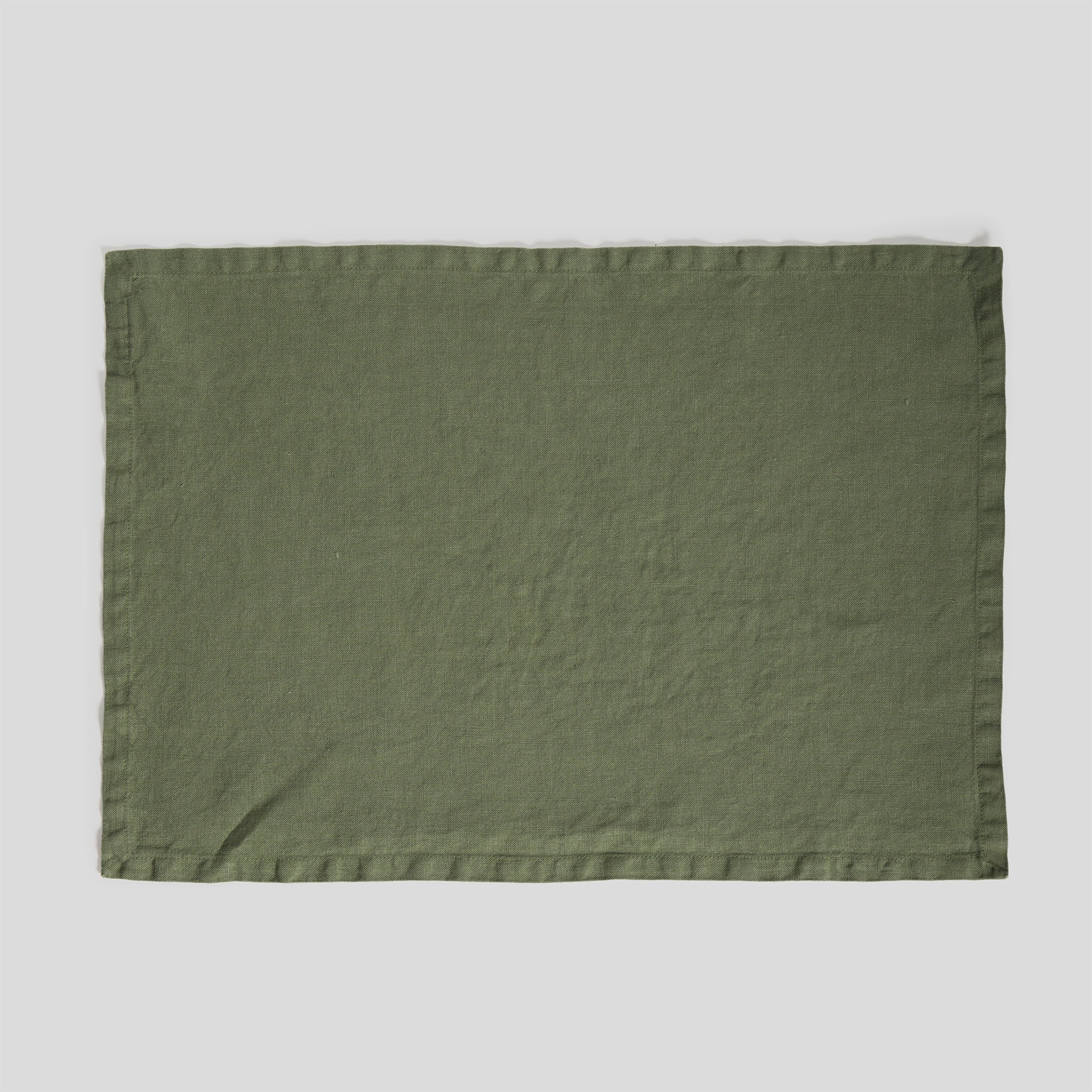 Olive heavy linen placemat featuring a rich, textured weave and clean edges.