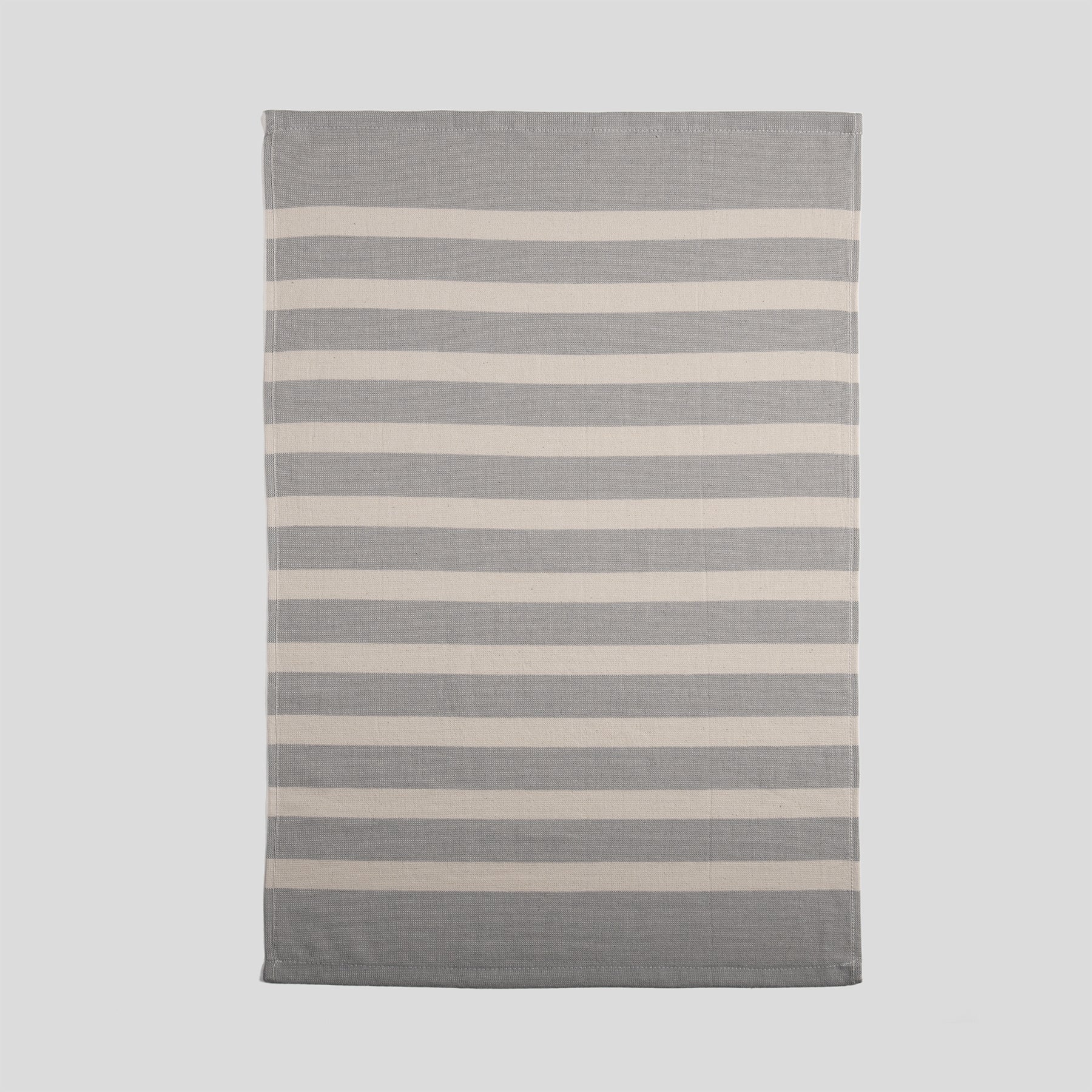 Cotton kitchen towel in mist grey with a smooth front and horizontal stripe pattern.